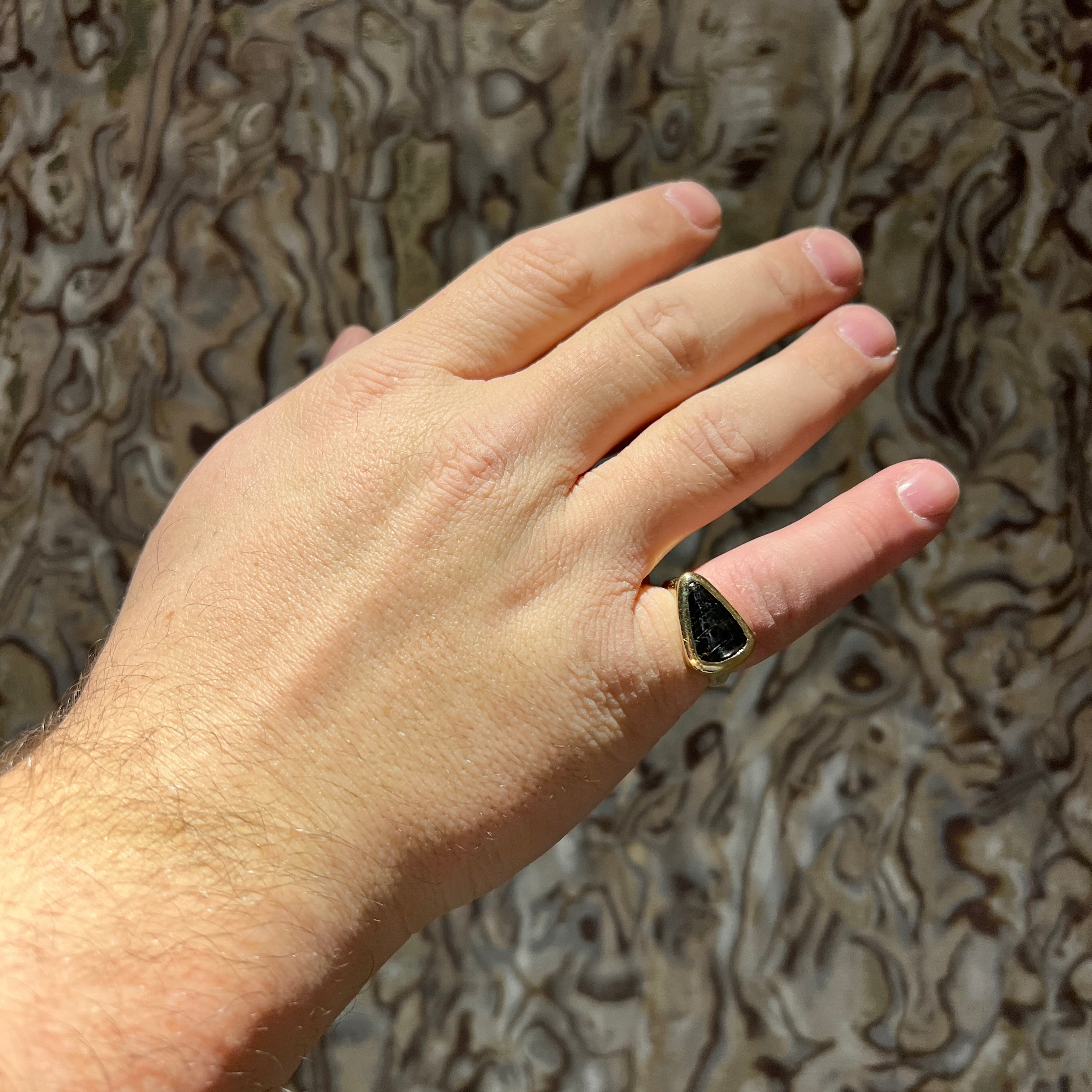 Close up of man's custom ring set it yellow gold