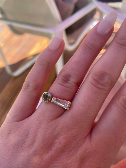 Closeup of tapered baguette diamond and sapphire ring on hand