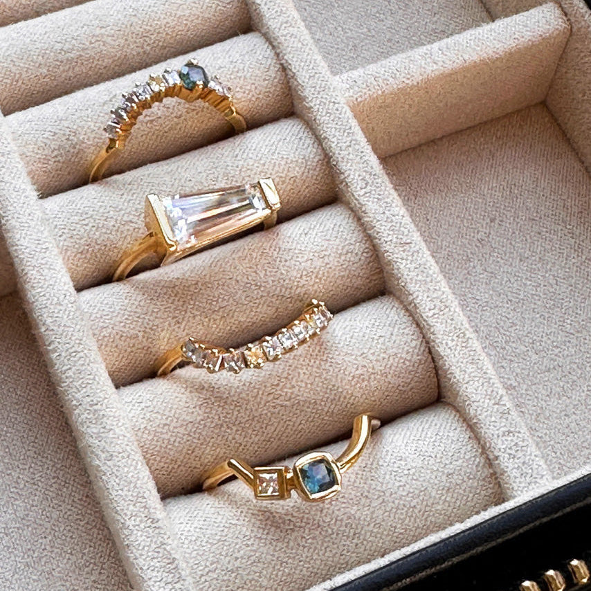 Set of gold rings with gemstones in a jewelry box